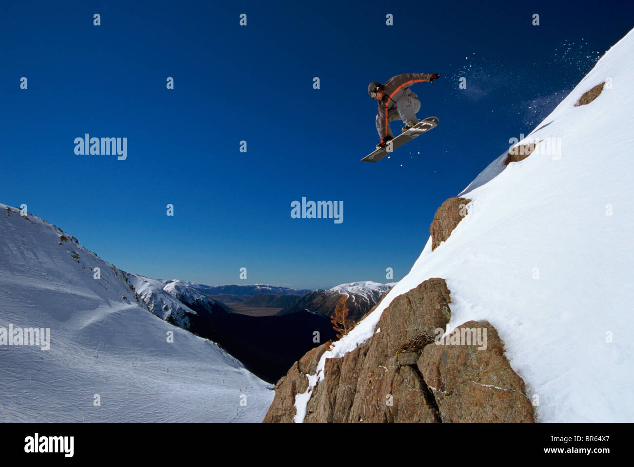 snowboarder drops a cliff in new zealand Stock Photo