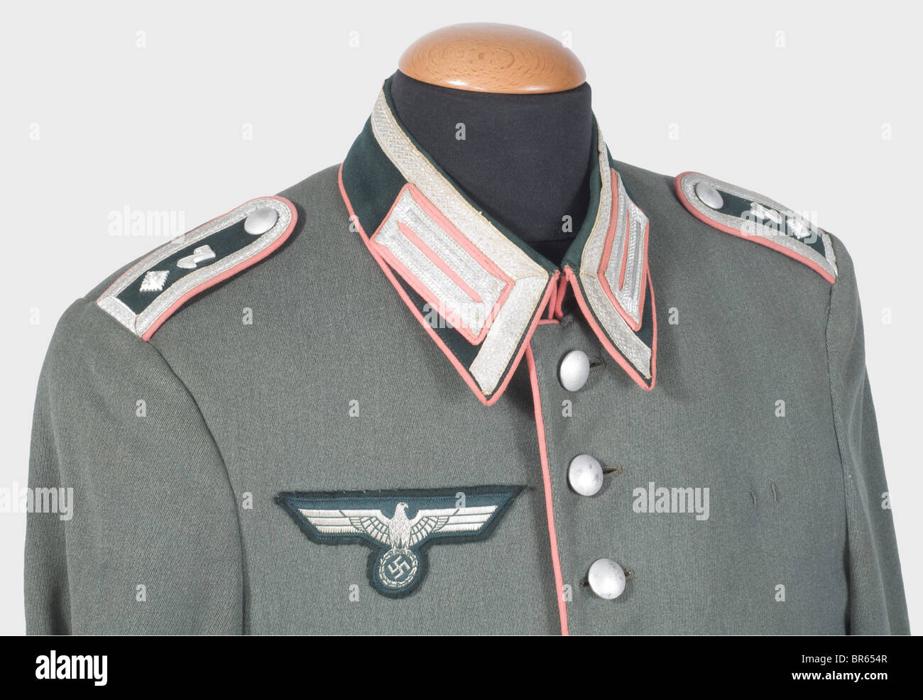 A dress uniform for a Feldwebel of the 7th Panzer Division., A field grey gabardine parade jacket with dark green collar and cuffs, pink coloured piping and collar patches (with silver lace), sewn-on shoulder boards, woven silver eagle on a dark green backing, green silk lining with a reinforced passage for a bayonet and the tailor's label, 'Eduard zum Felde - Eisenach', and a wearer's label in the inner pocket as a Lance Corporal in 1935. Long, stone grey trousers with pink coloured piping. Unfaded colour. The 7th Panzer Division, the so-called 'Ghost Division, Stock Photo