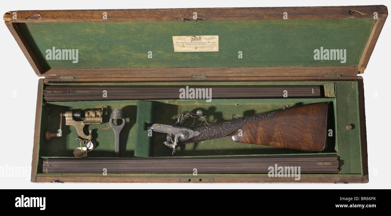 A Lefaucheux system: A Damascus double-barrelled rifle with interchangeable shot barrels, in its wooden case, John Donaghy, Amsterdam, no. PH35. Both barrel sets made from fluted, browned, finest rose Damascus: Rifle barrels, 8-grooves in 15 mm cal., optically partially bright or rough, require cleaning, length 74.5 cm. Shot barrels in 17 mm cal., bright, length 77 cm. Double trigger. Rifle barrel rib with foldable rear sights, signed in Gothic gold letters 'John Donaghy Amsterdam', shot barrel rib signed 'Damas Turc'. T-lock. Finest engraved light frame with g, Stock Photo
