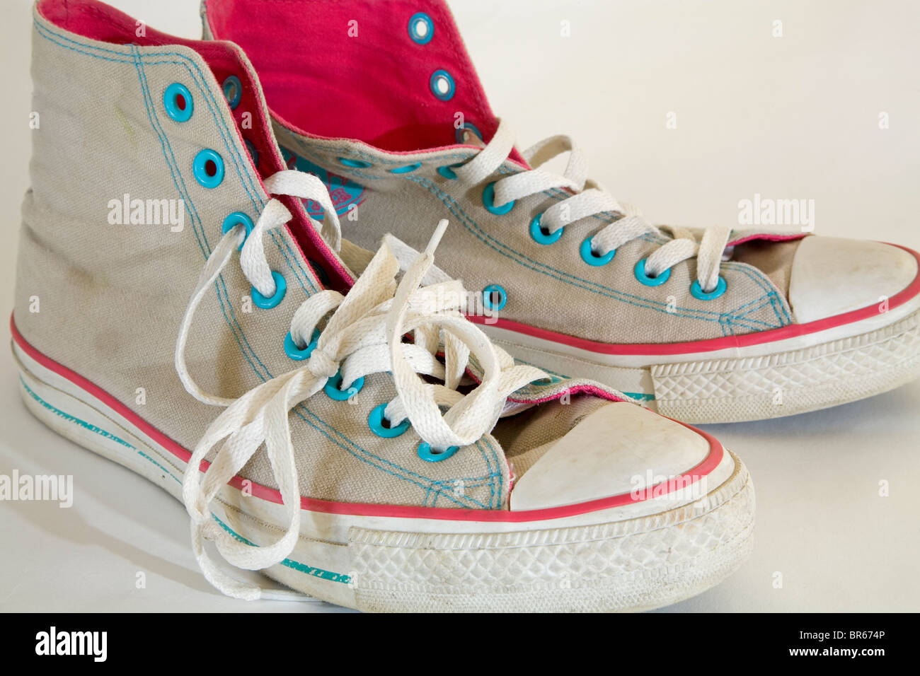 A pair of old, used, high-topped Converse sneakers or tennis shoes. Stock Photo