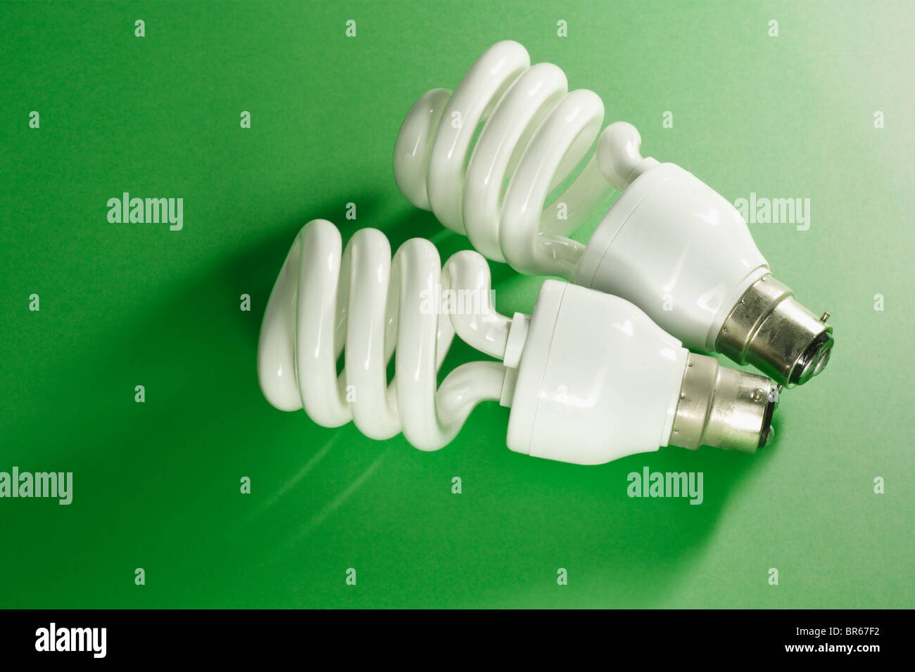 Energy saving light bulbs on green background Stock Photo