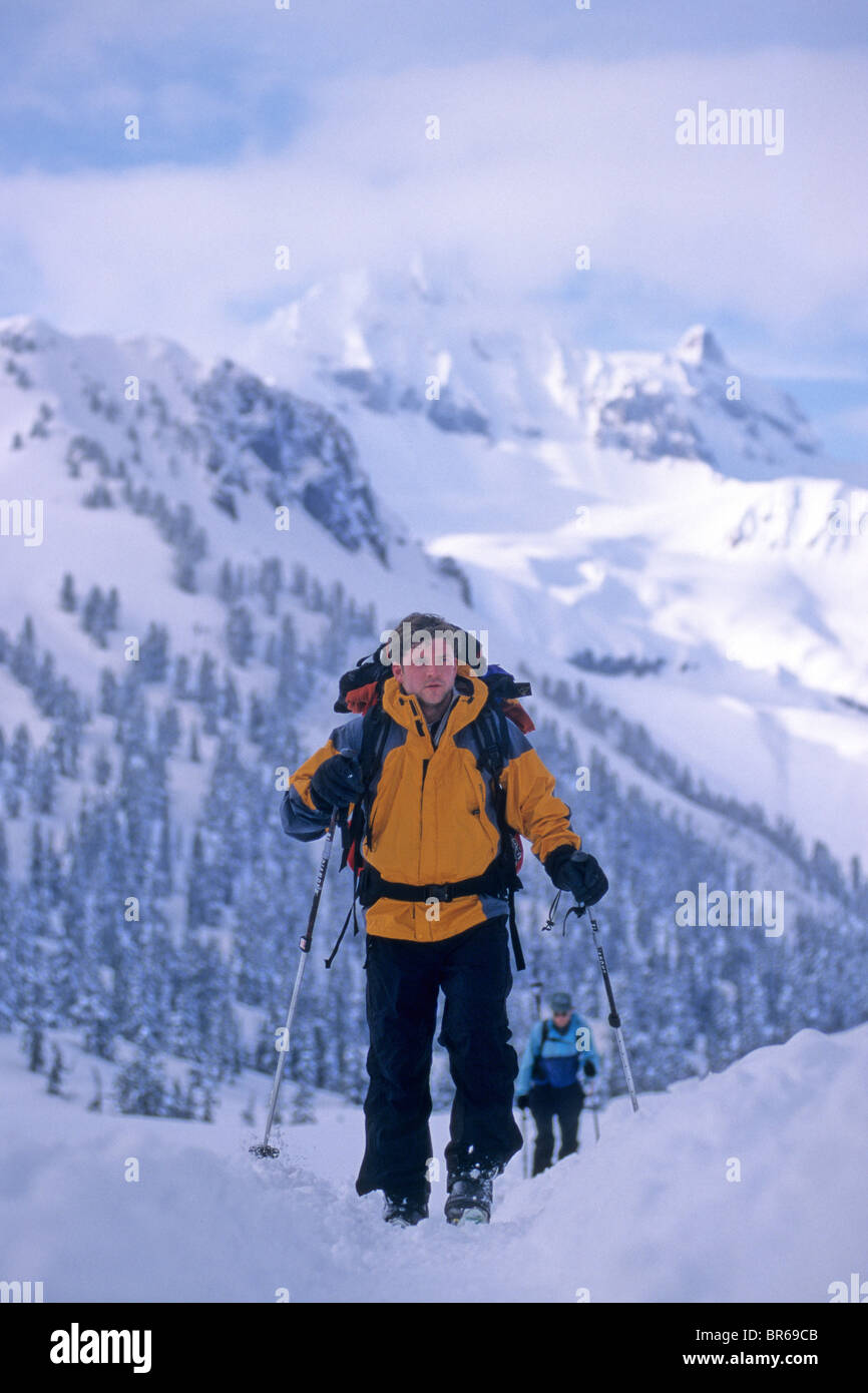 Two men telemark ski climb a peak in Banff National Park Alberta Canada