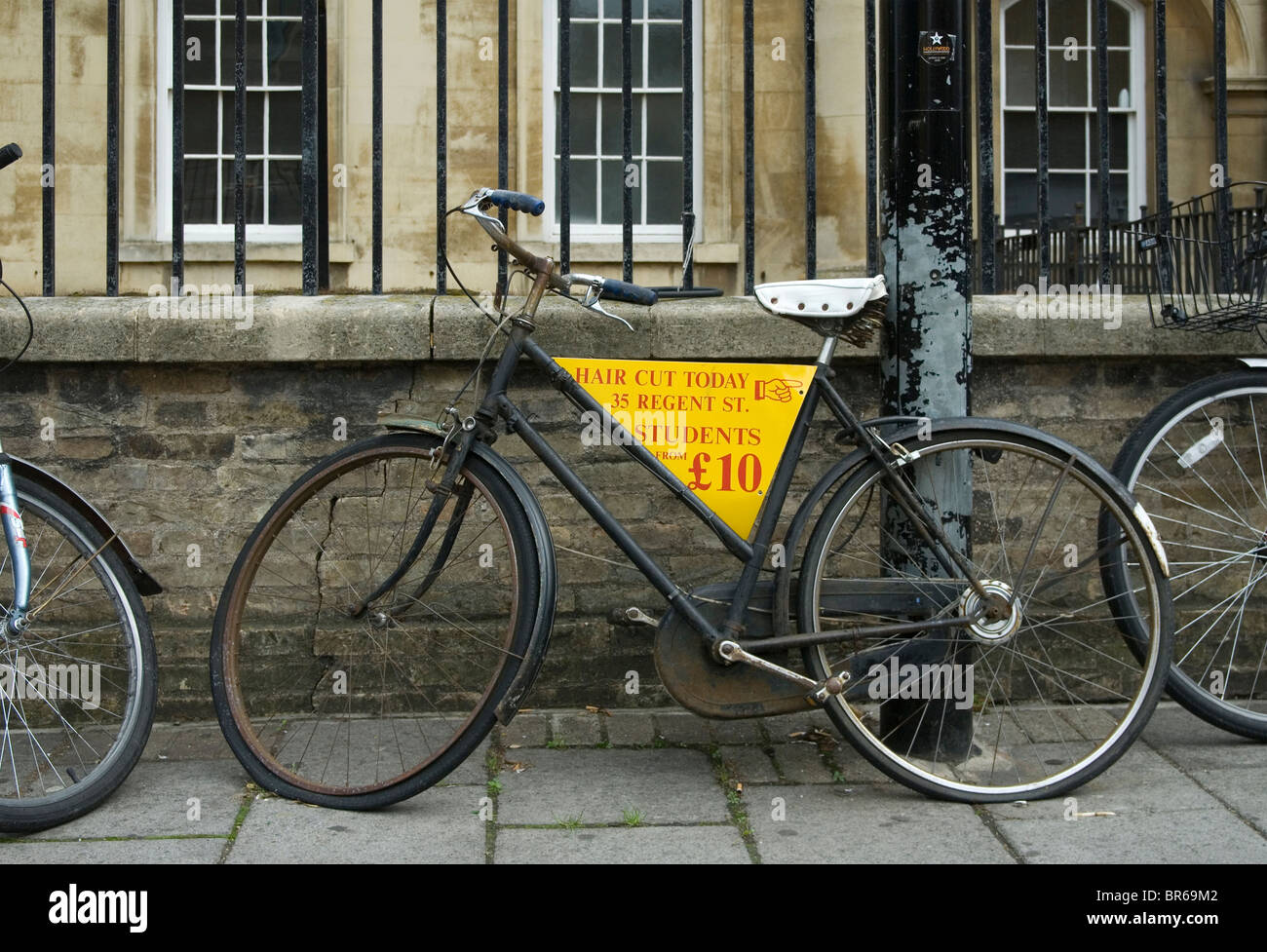 Bicycle in central Cambridge being used to promote a hairdresser's shop Stock Photo