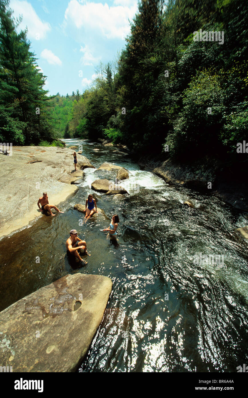 Swimmers cool off in a river. Stock Photo