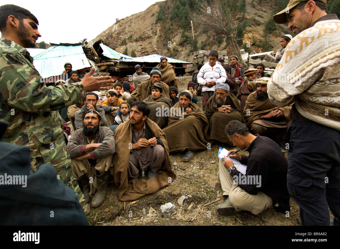 Pashtun men talk to a UN assessment team and Pakistan army escort upper Allai Valley Northwest Frontier Province Pakistan Stock Photo
