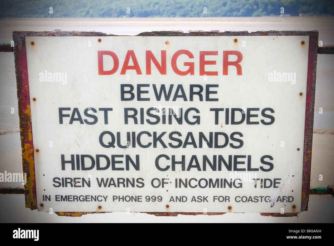 Danger sign warning of fast rising tides, quicksands and hidden channels. Stock Photo