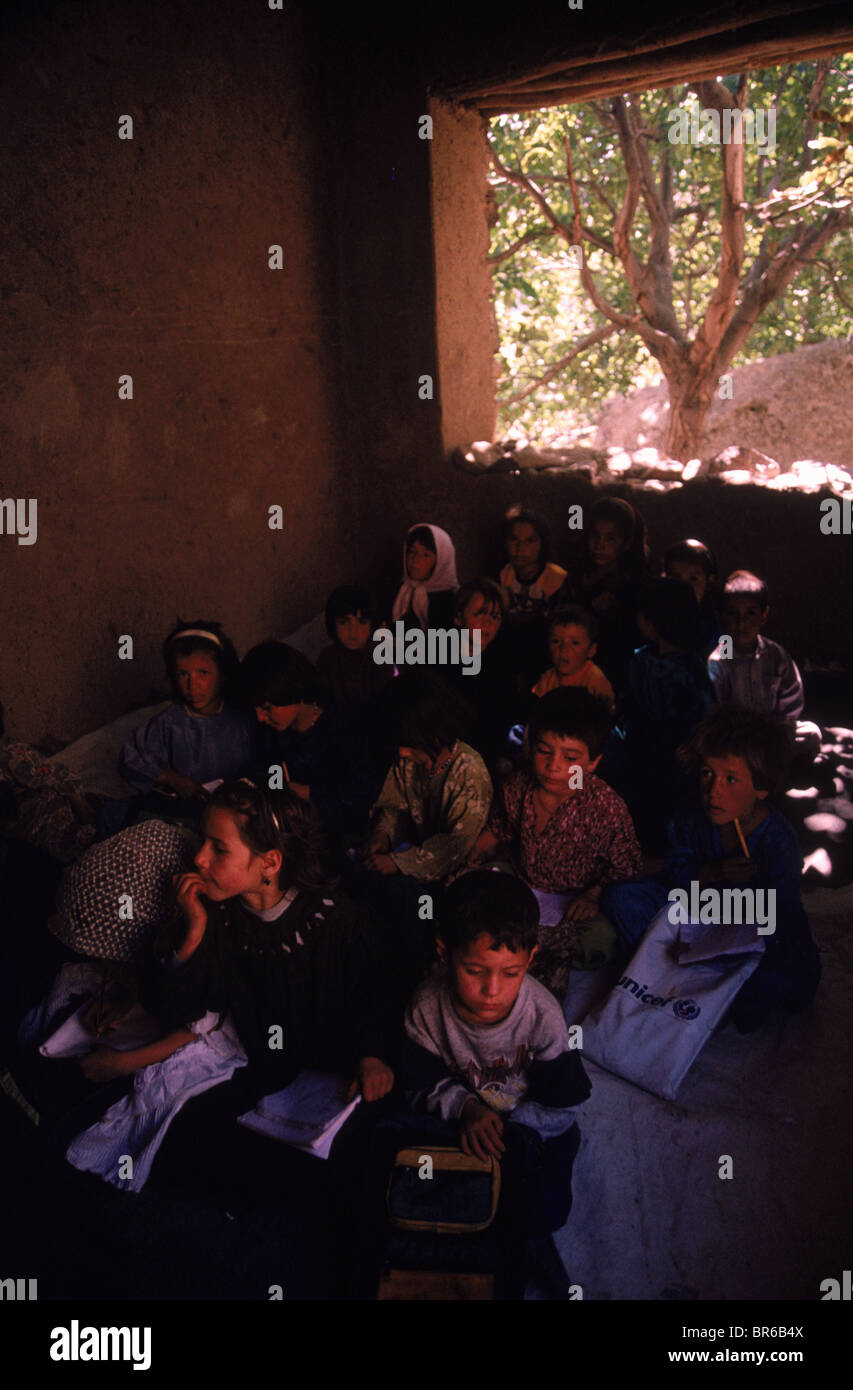 Young school children study in a school damaged during the Afghan-Soviet war Panjshir Valley Stock Photo