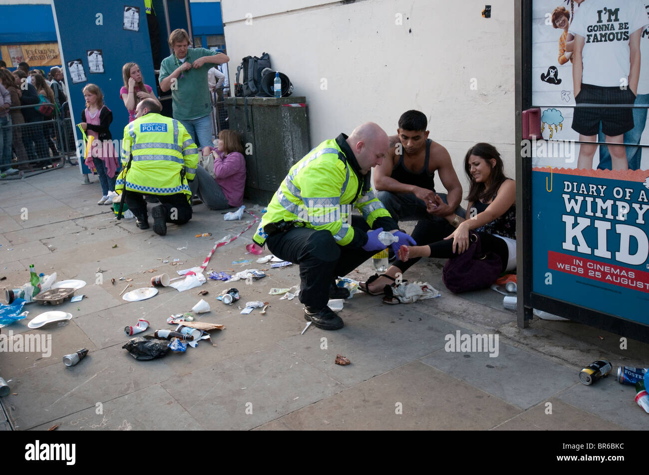 Police helping injured at Notting Hill  Carnival in the streets of West London. Stock Photo