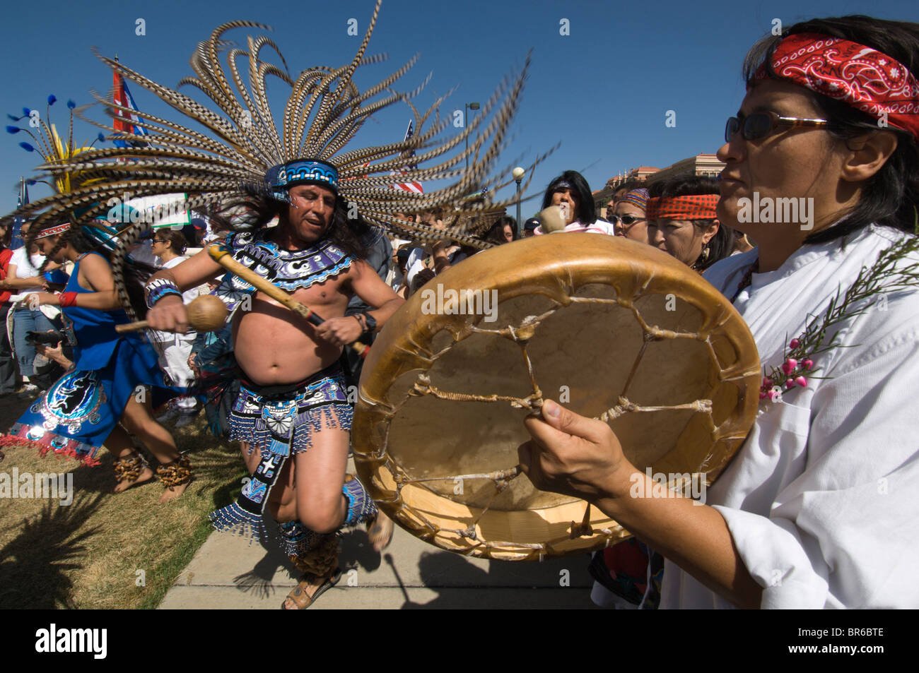 A drummer and dancers perform before the start of a march at a May Day ...