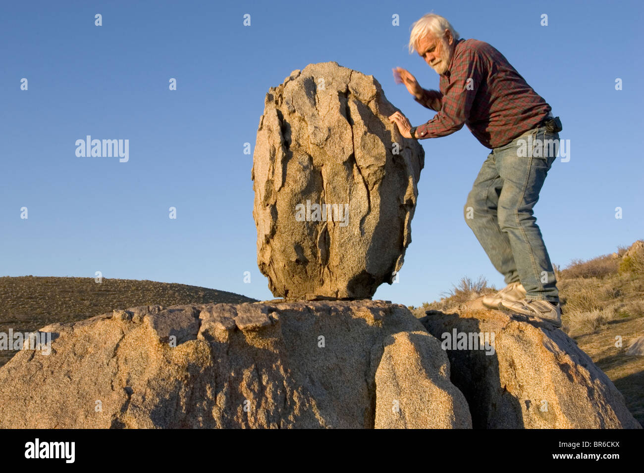 Professor Jim Brune inspects a precarious rock. Stock Photo