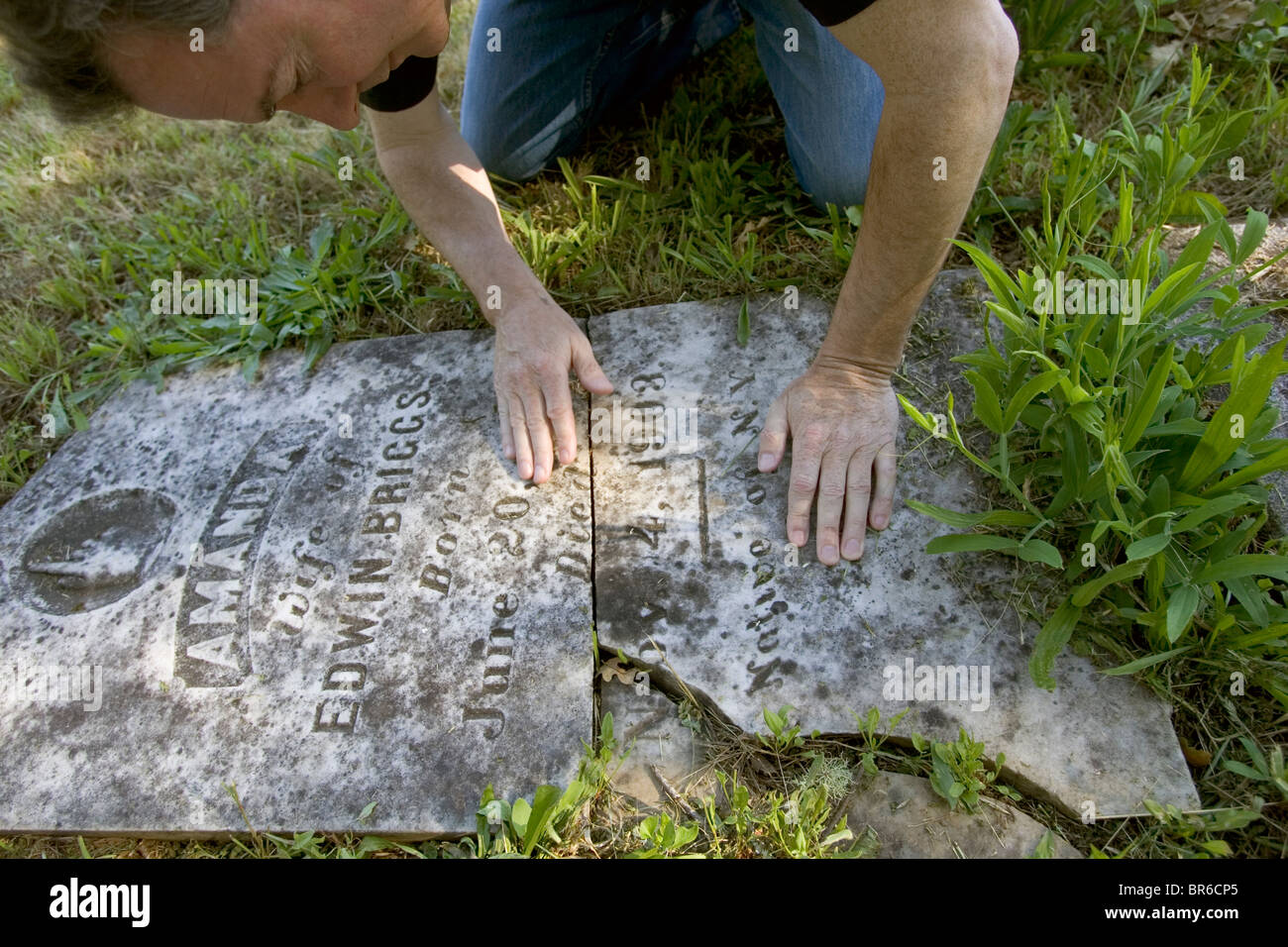 Seismologist Jack Boatwright examines a broken headstone. Stock Photo