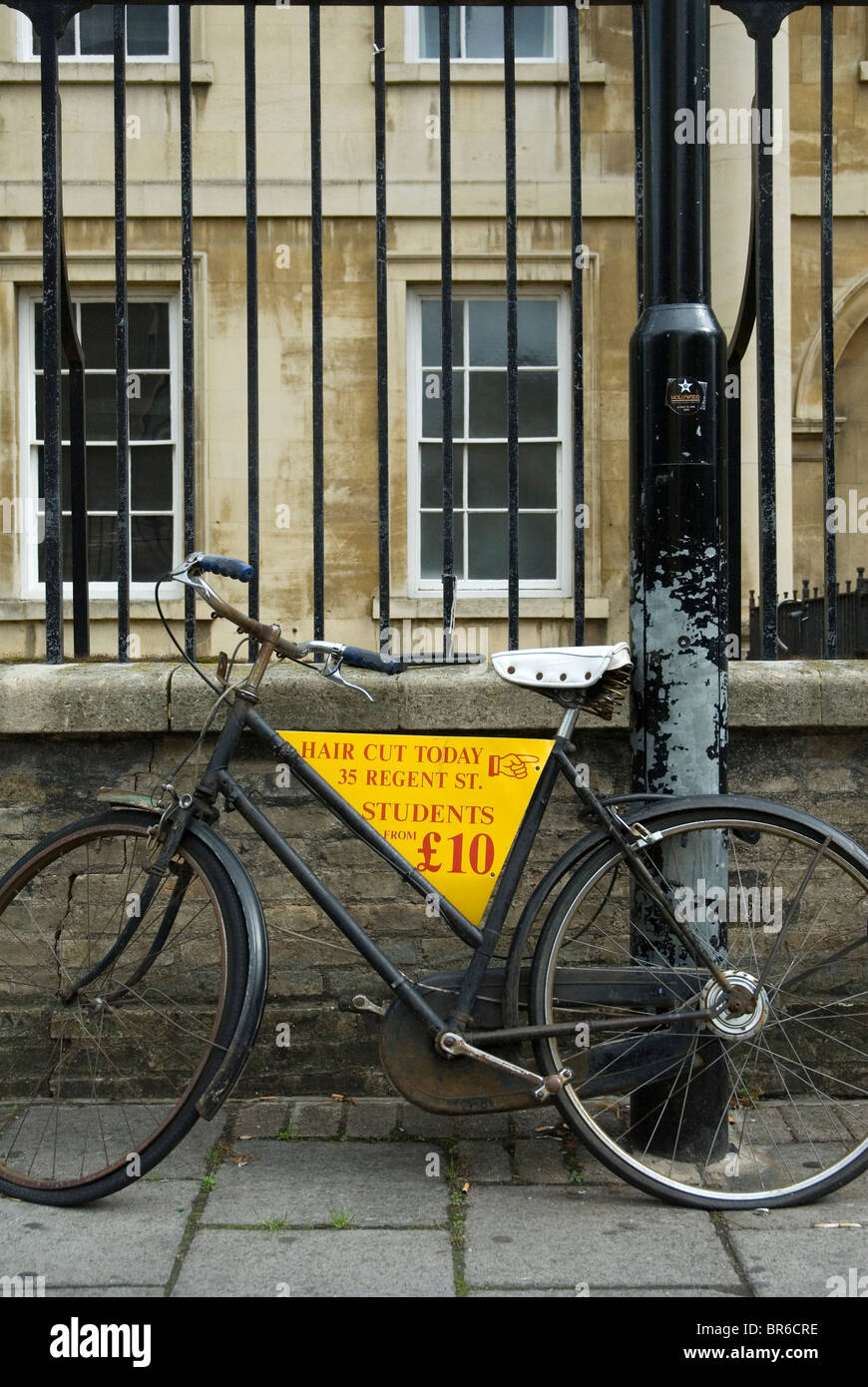 Bicycle in central Cambridge being used to promote a hairdresser's shop Stock Photo