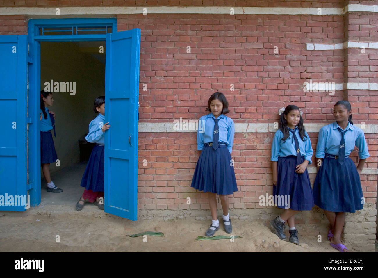 school girls in front of Earthquake retrofitted school in Nepal. Stock Photo
