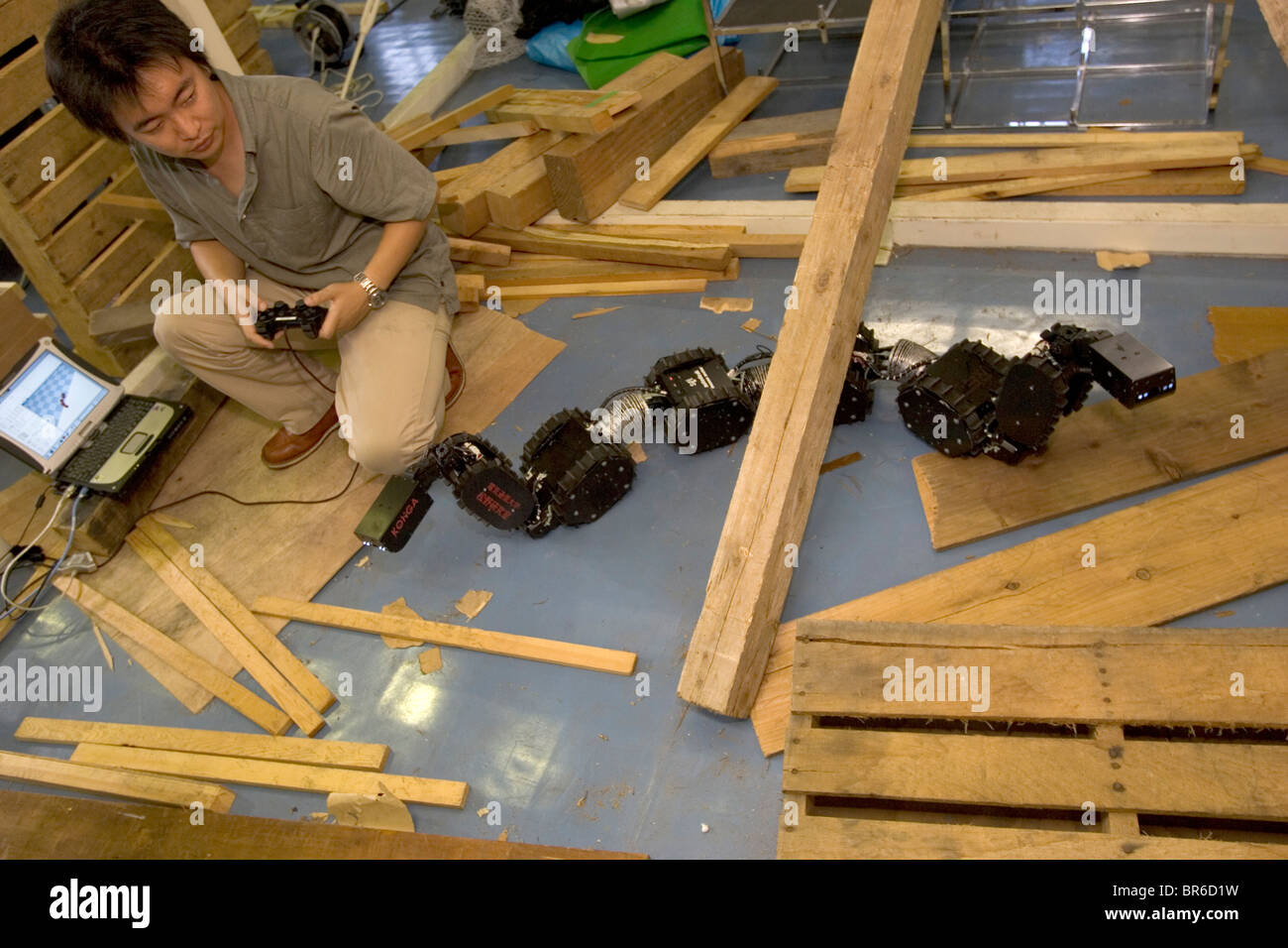 A Japanese scientist tests a rescue robot. Stock Photo