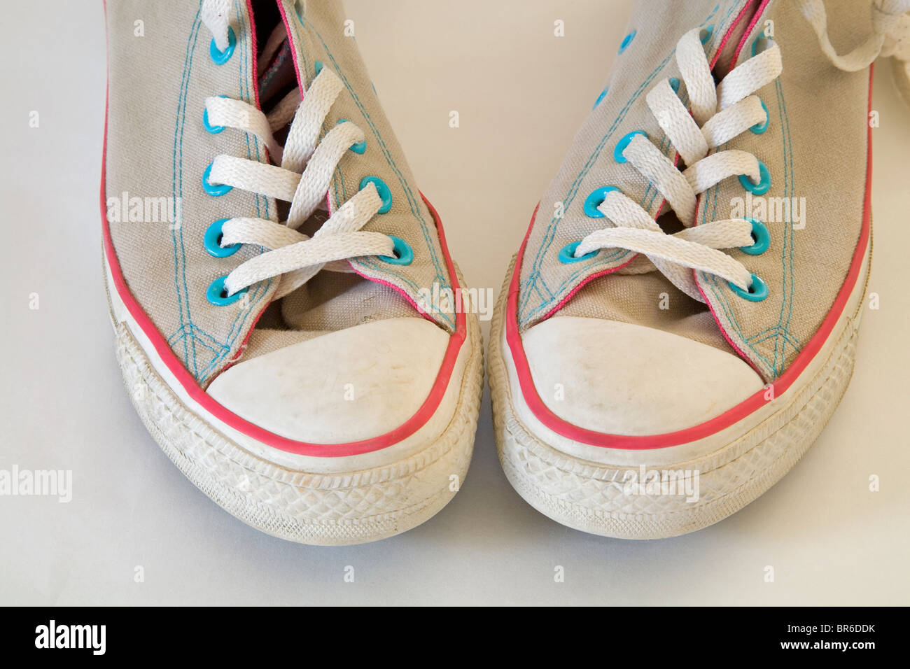 A pair of old, used, high-topped Converse sneakers or tennis shoes. Stock Photo