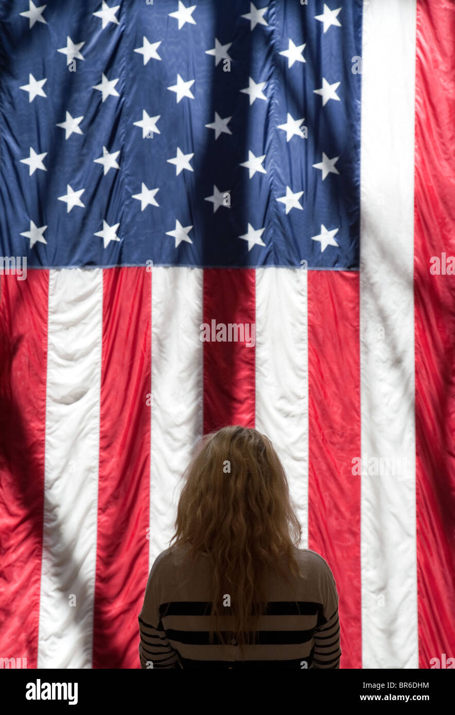 A blond teenage girl standing with the American Flag, the Venetian Hotel, Las Vegas USA Stock Photo