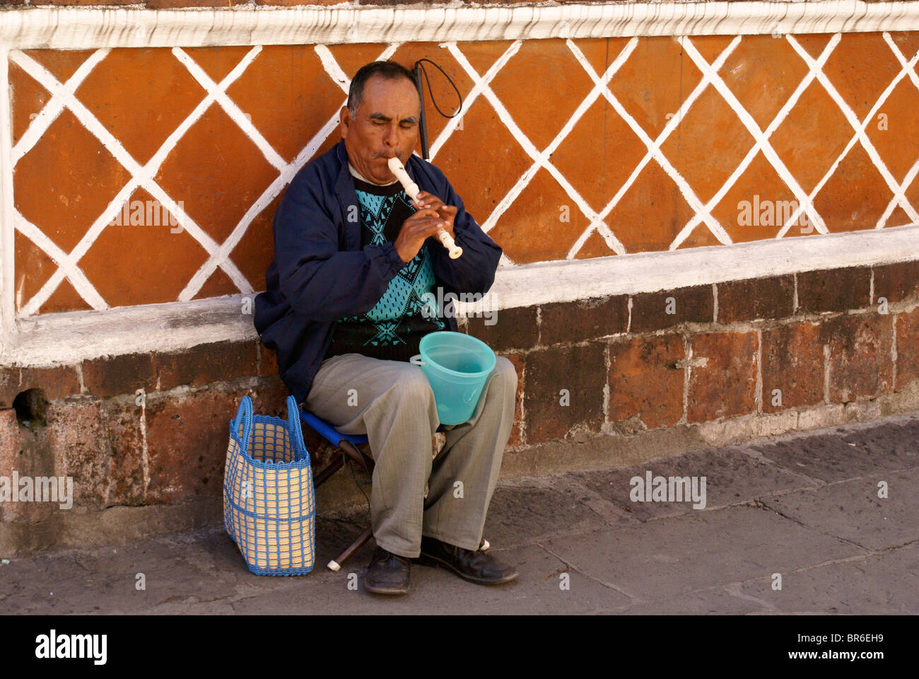 Blind man playing a recorder in the city of Puebla, Mexico. Stock Photo