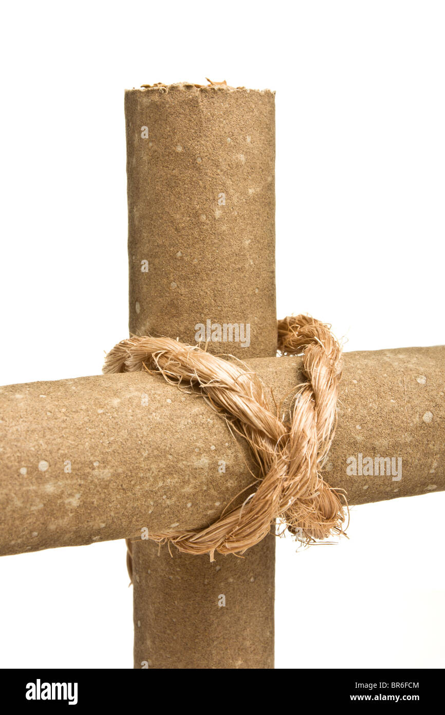 Anti Smoking concept of crucifix made from 2 cigars tied with rope isolated on white. Stock Photo