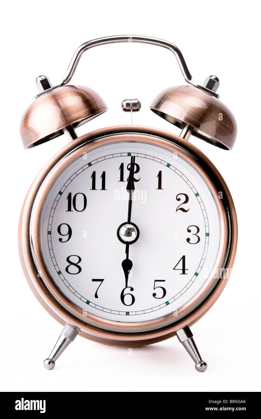 Copper alarm clock showing 6 o'clock on white background Stock Photo