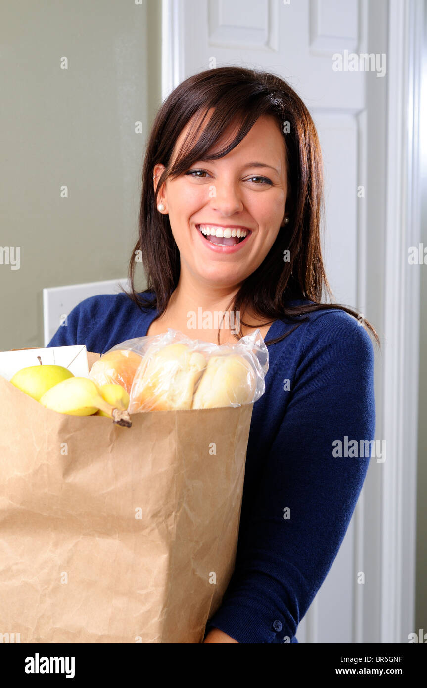 Happy Young Woman Carrying Her Groceries Into The House Stock Photo Alamy