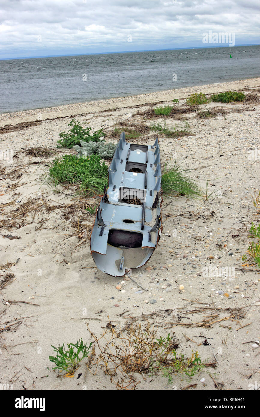 Broken crew boat hull washed up on beach Long Island NY Stock Photo