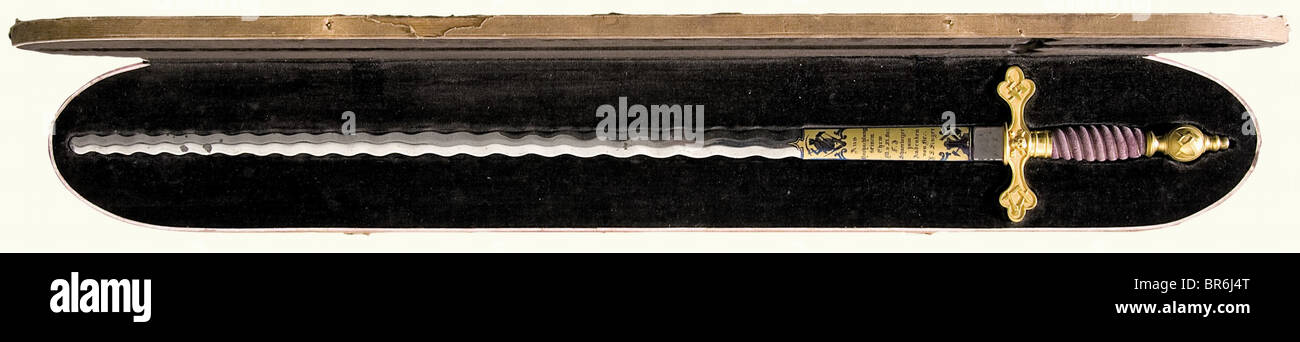 A magnificent cased masonic sword, German, end of the 19th century A blade with undulating edges and blunt point. Both sides of the ricasso are blued and bear a gilded cartouche with a presentation dedication, 'Aus Hochachtung seinem Ehrw. M.v.St. Br.. F.J. Schneeberger zum Andenken von Br.: D.S. Singer' (With Respect to his honourable M.v.St. Br.: F.J. Schneeberger in memory of Br.: D.S. Singer). The reverse side bears Masonic symbols, such as the star of David with 'G' in the center, the circle, dagger, the trowel, book, or scythe. Gilded and partially polish, Stock Photo