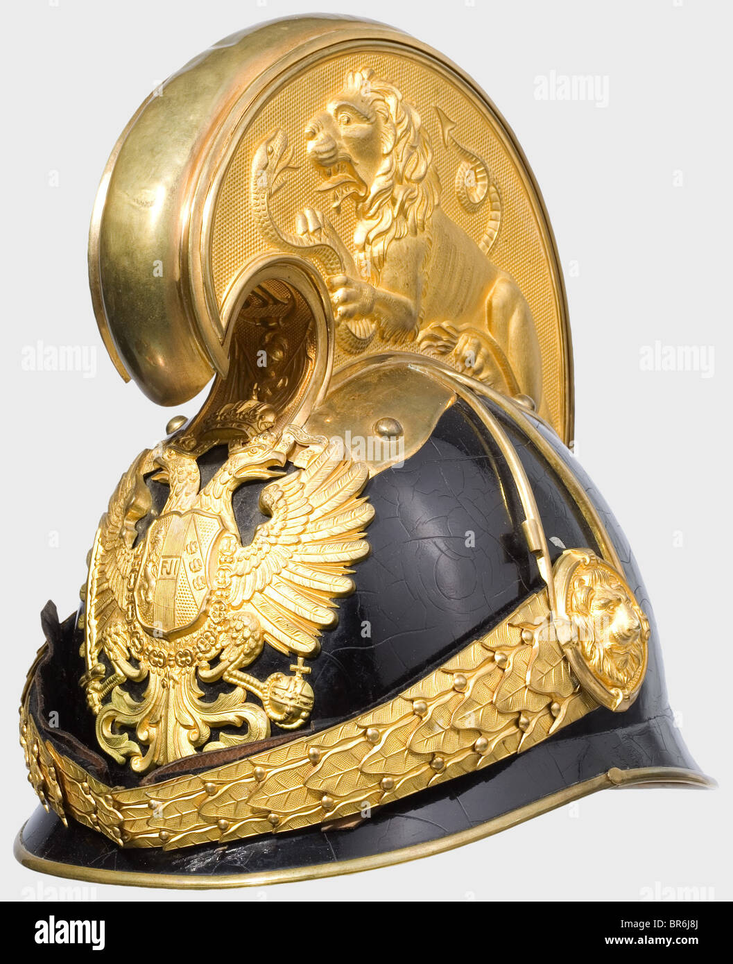 A model 1905 helmet for dragoon officers., Black-lacquered, slightly  crazed, light metal body with fire-gilt mountings. The crest stabilised  with a recently added light metal strap. Leather sweat band, lining  missing. Also