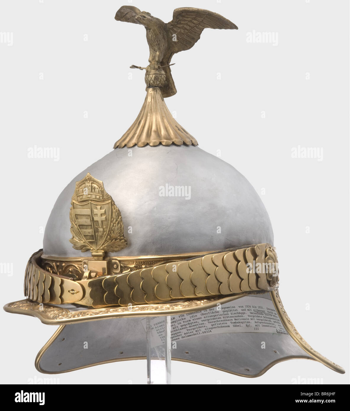 A helmet for generals, 1924 - 1931. Drawn aluminium skull, the surface smoothed and coated with silverbronze. Embossed and gilt brass bands along the perimeter, gilt chinscales, coat of arms emblem and fluted crown piece. The helmet surmounted by a brass eagle carrying a sabre in its talons (original?). Black lining of leather and cloth. historic, historical, 1920s, 1930s, 20th century, 20th century, helmet, helmets, headgear, headgears, protection, protective, uniform, uniforms, utensil, piece of equipment, utensils, outfit, outfits, headpiece, headpieces, obj, Stock Photo