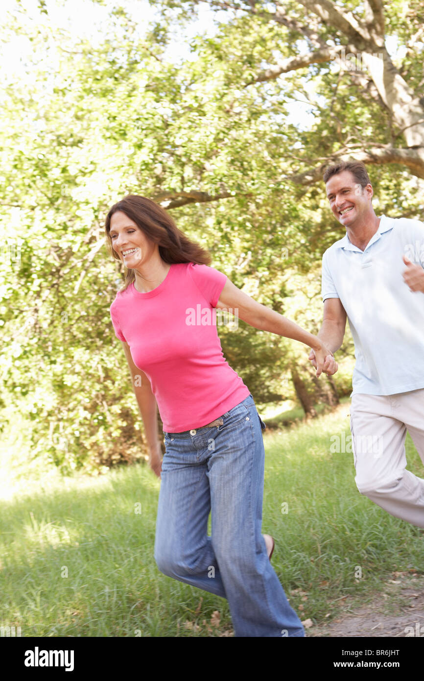 Portrait Of Young Couple Walking In Park Stock Photo - Alamy
