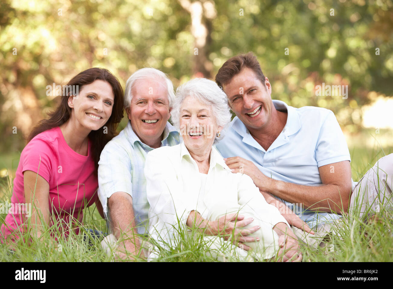 Senior Couple With Grown Up Children In Park Stock Photo