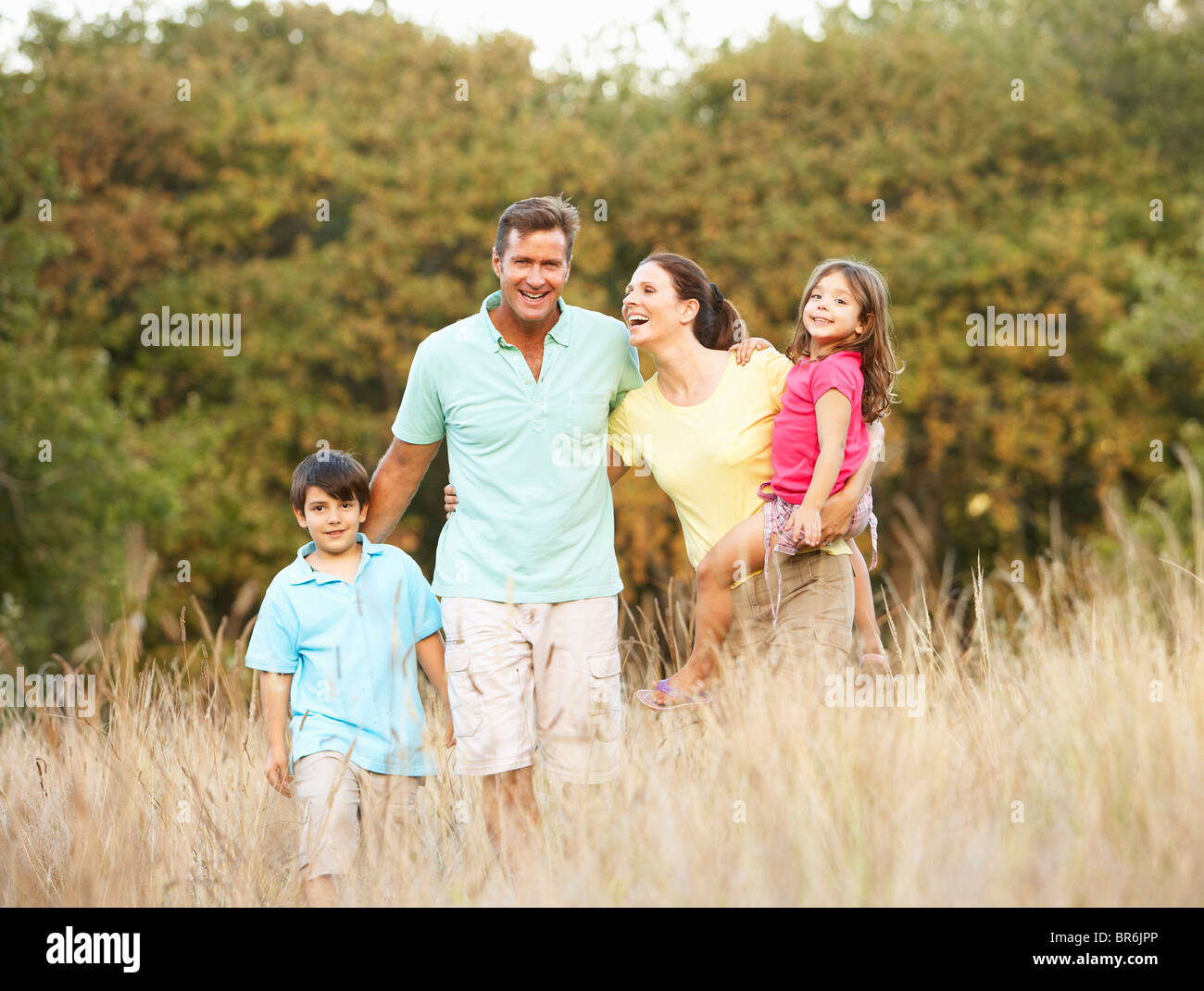 Family Enjoying Walk In Park Stock Photo