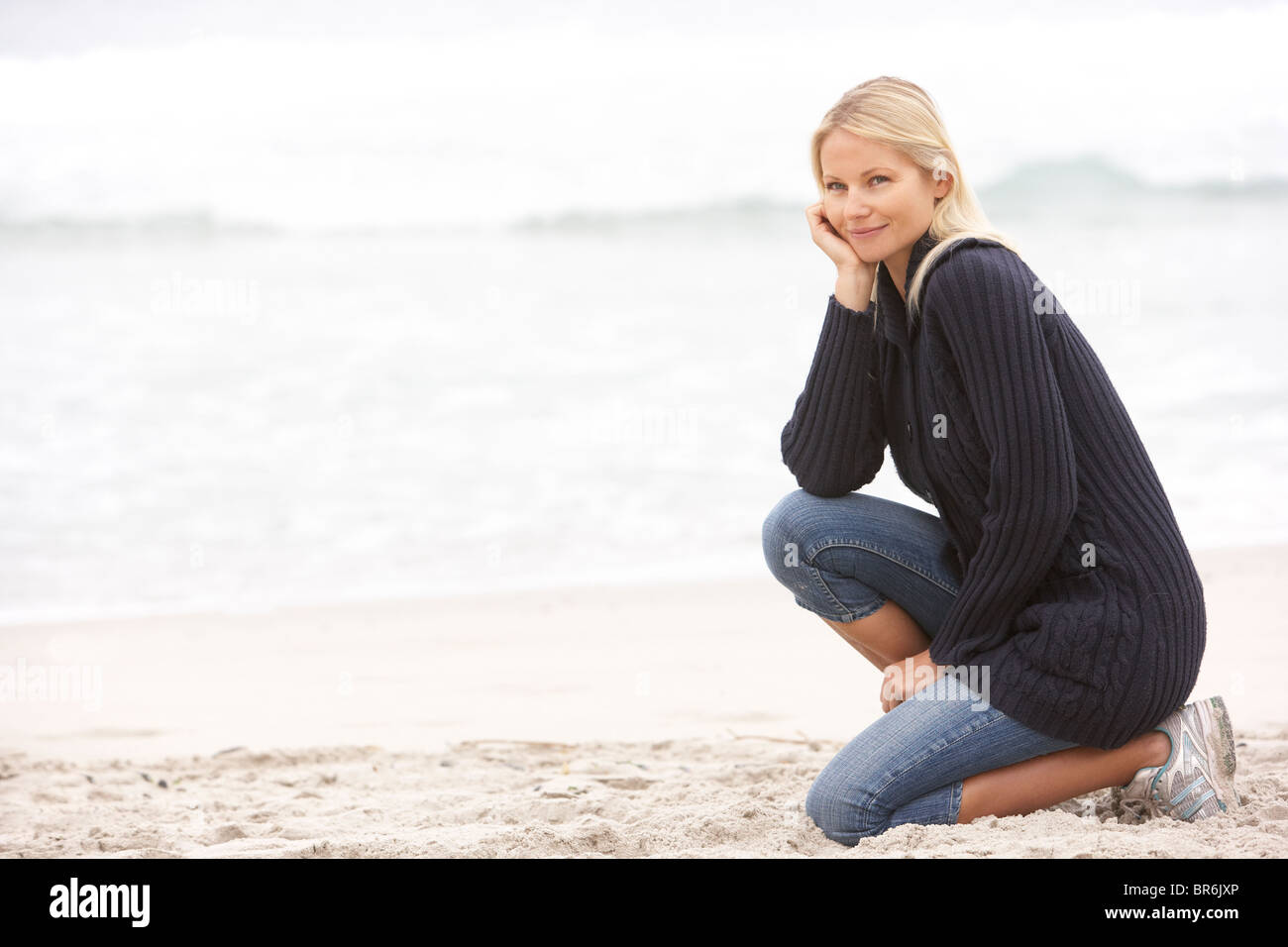 Woman kneeling on shore hi-res stock photography and images - Alamy