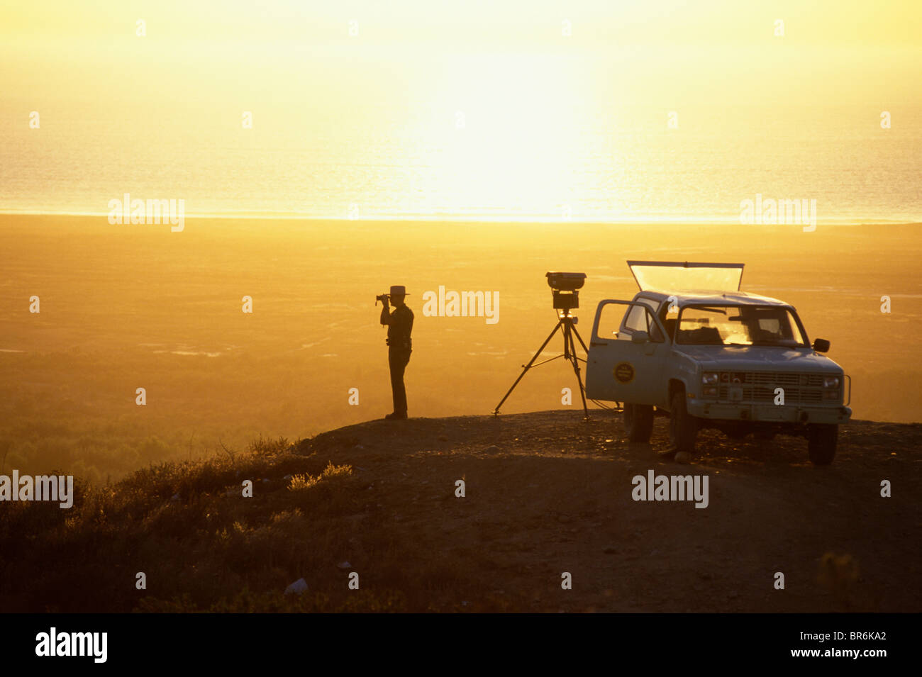 A Border Patrol Agent Sets Up An Infrared Scope On A Ridge Top At 