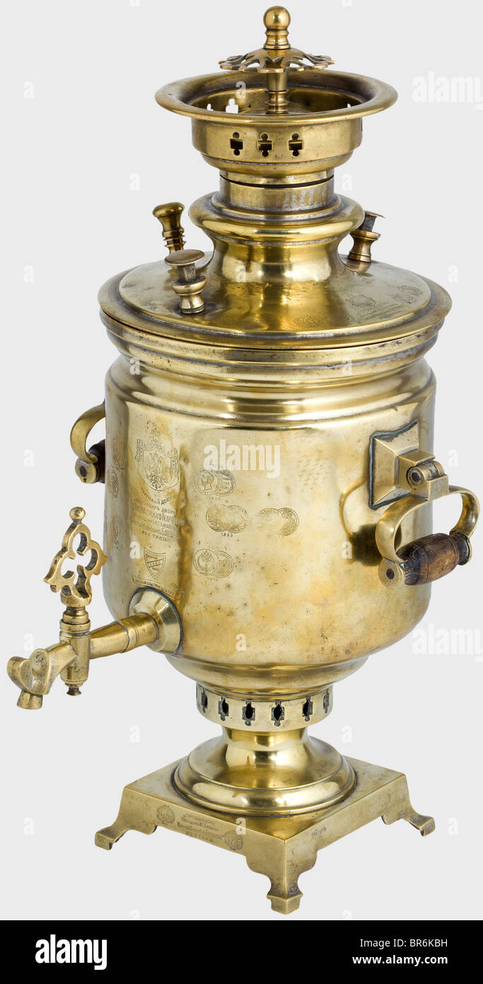 A Tula-samovar, purveyor to the court Nikolay Ivanovitsh circa 1915. Brass with wooden grips. Maker's marks with the Russian double-headed eagle along with numerous medals (1855 - 1912) on the front and the lid. Height 51 cm. The manufactory of Batashov was founded in 1825 and is considered to be the first samovar factory in Tula. historic, historical, 1910s, 20th century, vessel, vessels, object, objects, stills, clipping, clippings, cut out, cut-out, cut-outs, Stock Photo