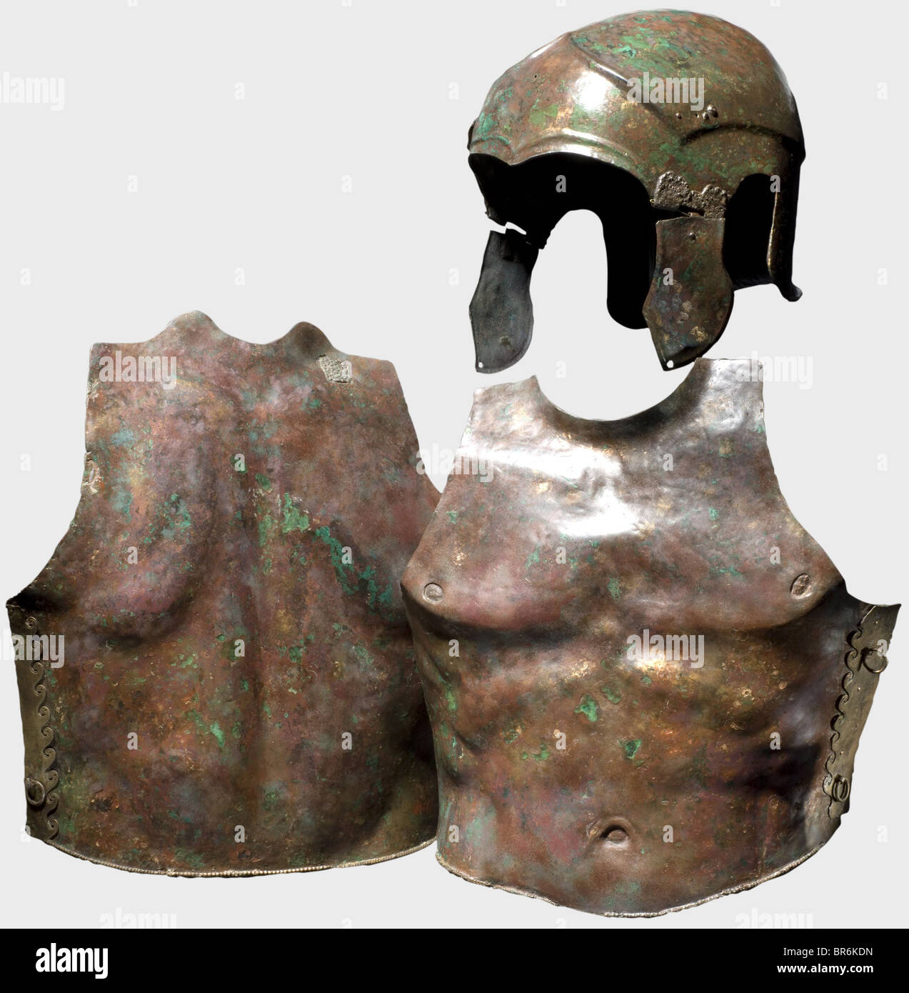 A Chalcidian helmet and muscle armour, 5th/4th century B.C. Bronze helmet with a clearly offset calotte, large ear cutouts, contoured brow gable and arched eye cutouts. Curved cheek pieces on hinges with large decorative plates. Holes in the forehead area and on the rear side. Remnants of a riveted wing adornment on the right side. Corresponding rivet holes on the left side. Height 25 cm, weight 868 g. Red-brown patina with green areas, numerous supplements, the interior reinforced with fibreglass. Axel Guttmann Collection (AG 460a, AG 602/H 151), acquired in 1, Stock Photo