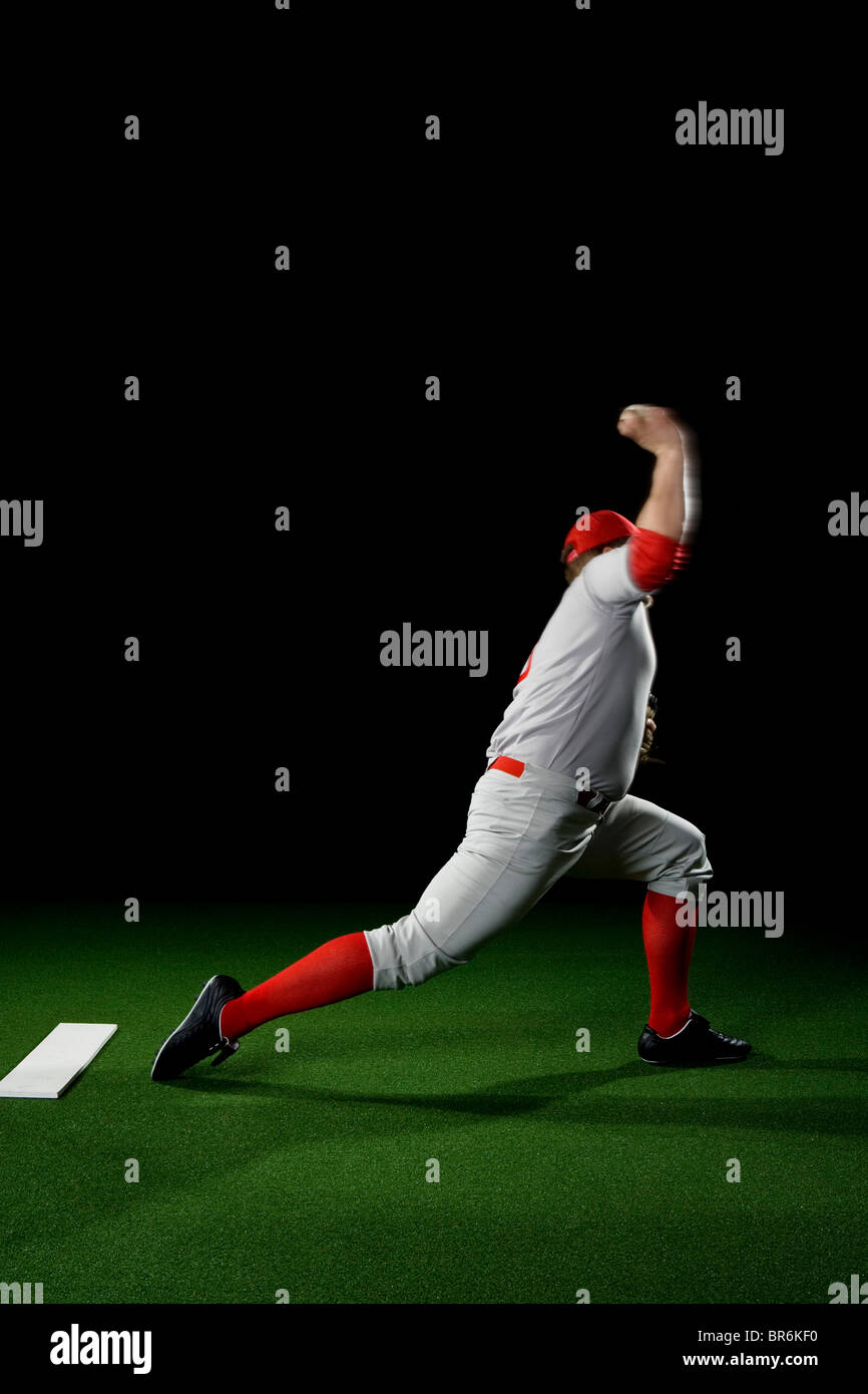 A baseball player after making a pitch Stock Photo