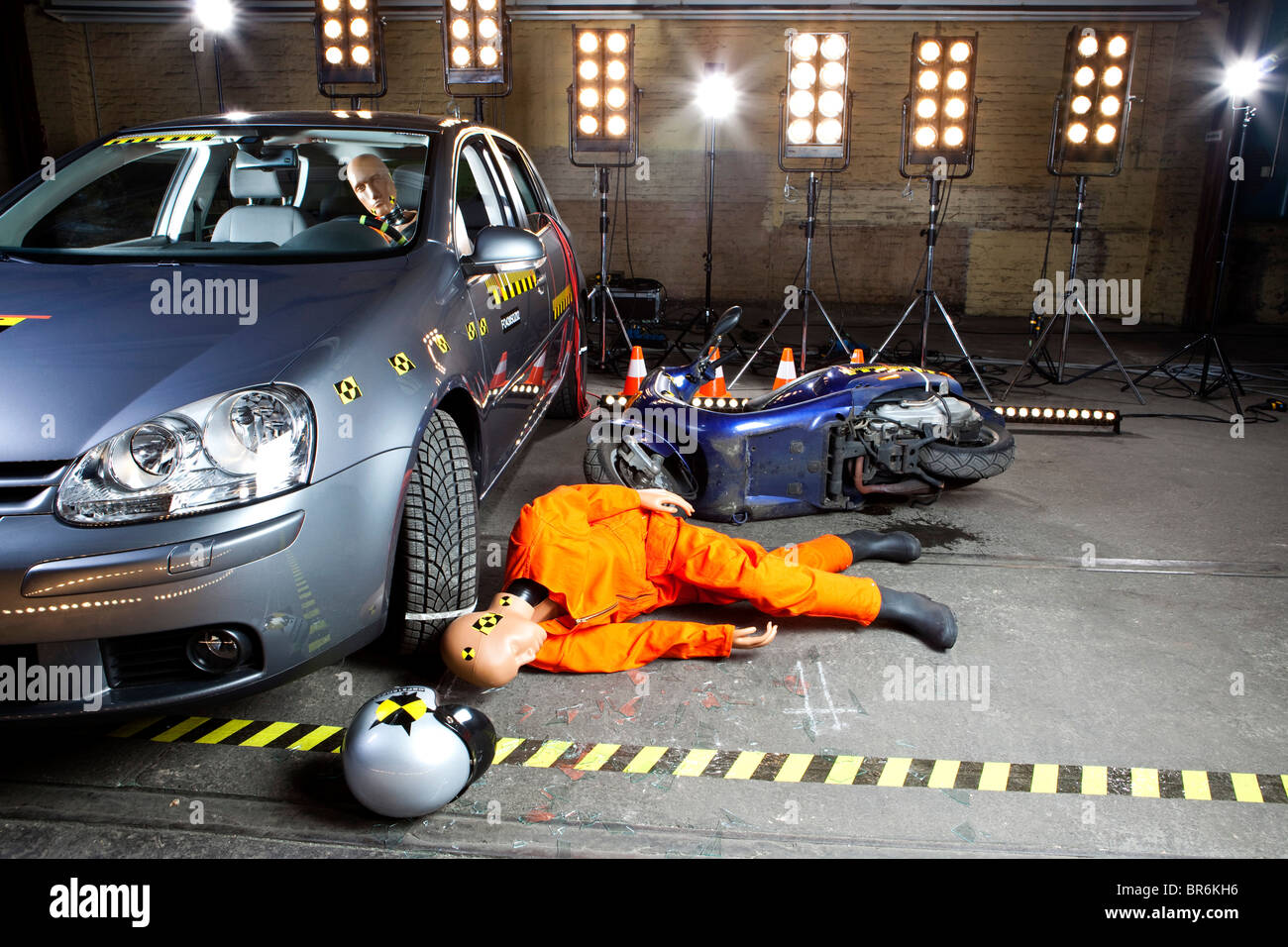 A crash test dummy on ground after scooter crashed into car Stock Photo