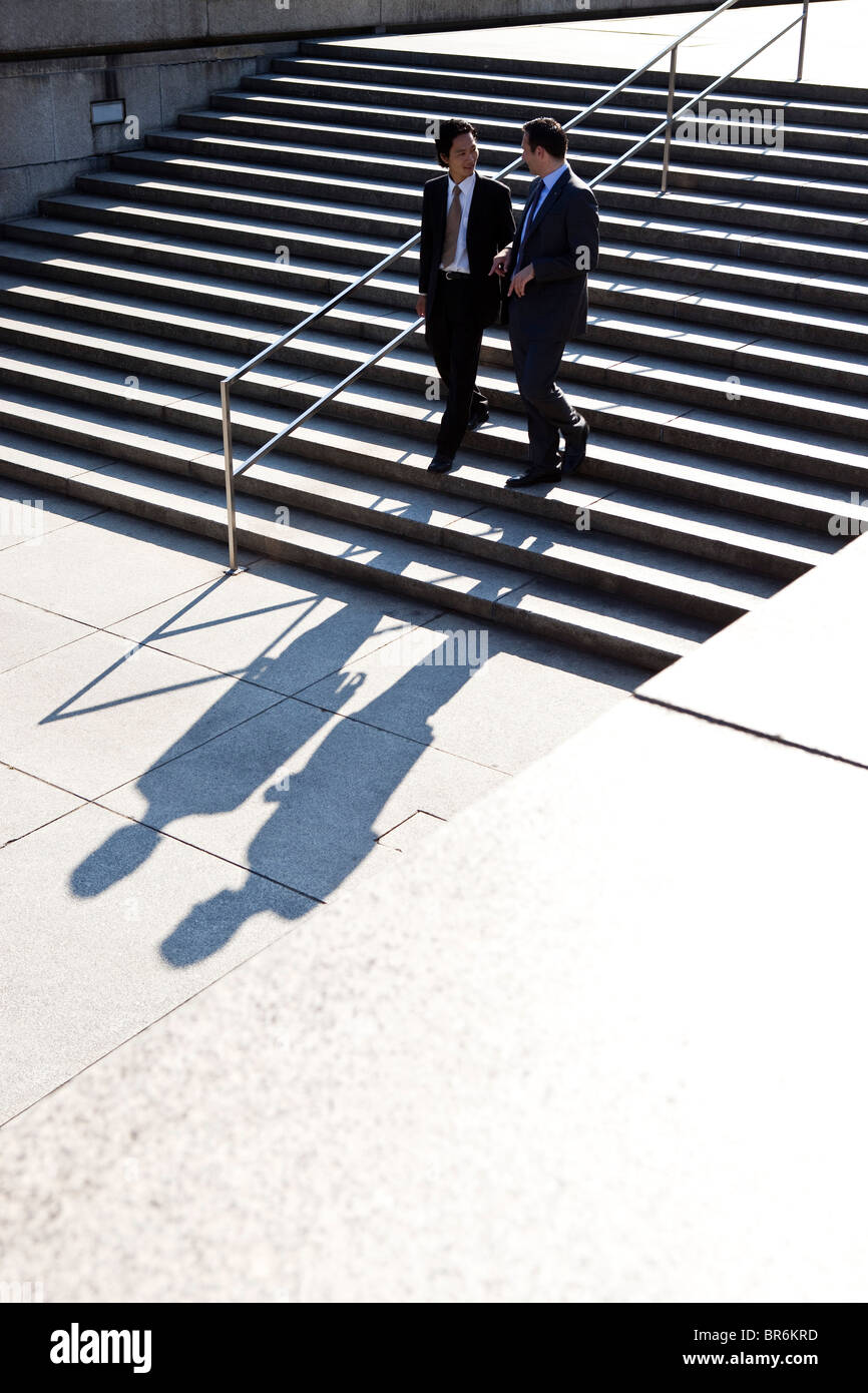 Two businessmen walking down stairs, outdoors Stock Photo - Alamy