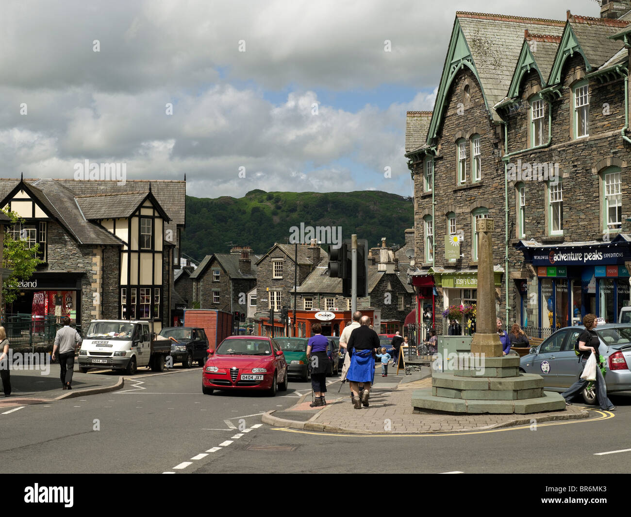 People tourists visitors in the town centre in summer Ambleside Cumbria England UK United Kingdom Great Britain GB Stock Photo
