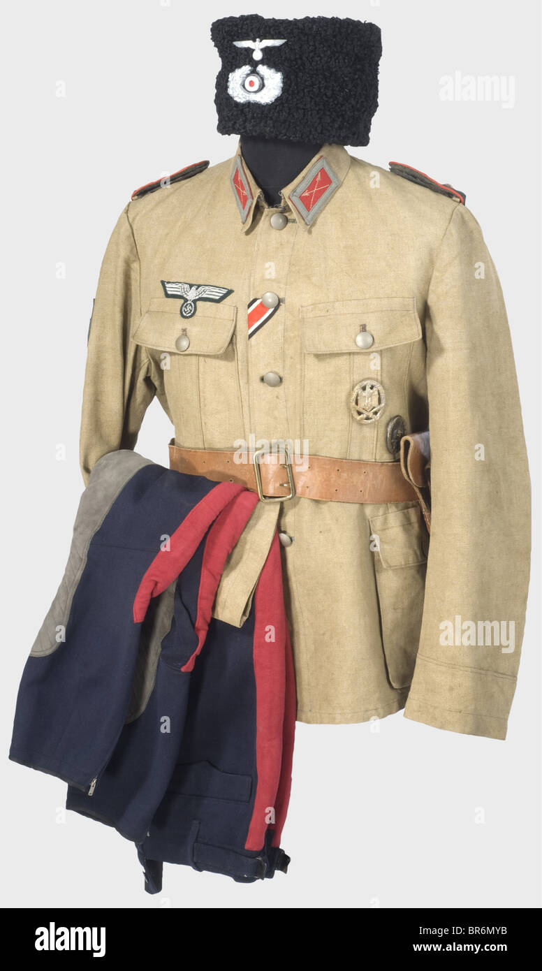 A uniform ensemble for a Cossack First Lieutenant., A papacha (Cossack lambswool hat) with black fur trim and a dark green top with a cross of yellow braid. Metal insignia. Beige coloured cotton lining. Tunic of sand coloured linen, complete with all insignia (different versions), and the General Assault Badge and Wound Badge in Black pins. Dark blue breeches with leather trim and broad red leg stripes. Brown leather belt with pistol holster. historic, historical, 1930s, 20th century, army, armies, armed forces, military, militaria, object, objects, stills, cli, Stock Photo