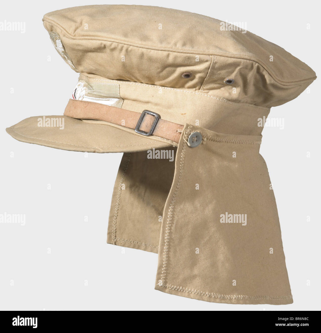 A tropical visor cap, of sand coloured cotton with woven emblems, four iron ventilation rivets, neck shade and leather chinstrap on zinc buttons. Red cotton lining with black RB number stamp and size stamp '57'. historic, historical, 1930s, 20th century, Air Force, branch of service, branches of service, armed service, armed services, military, militaria, air forces, object, objects, stills, clipping, clippings, cut out, cut-out, cut-outs, uniform, uniforms, clothes, piece of clothing, headpiece, headpieces, cap, caps, hat, hats, bonnet, bonnets, accessory, acc, Stock Photo