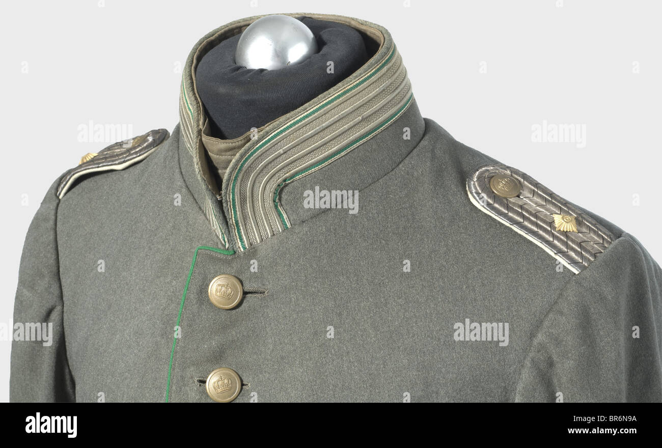 A field grey tunic for a First Lieutenant, in the Cuirassier Regiment Count Geßler (Rhenish) No. 8. Private purchase piece of field gray cloth with green piping, field grey crown buttons, and green silk lining. Broad field grey lace interwoven with green on the sleeves and collar. Sewn, woven silver shoulder boards with a black interweave and white backing. historic, historical, 19th century, Prussian, Prussia, German, Germany, militaria, military, object, objects, stills, clipping, clippings, cut out, cut-out, cut-outs, uniform, uniforms, clothing, clothes, ou, Stock Photo