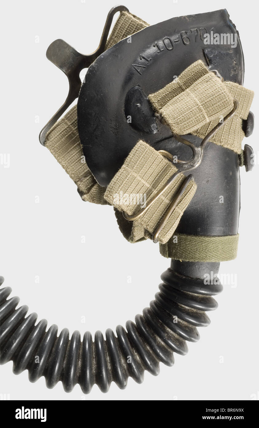 A type "A1 10 6701" oxygen mask for fighter pilots., Black rubber, complete with tube, yellow zinc-plated attachment clamp, coupling, and straps. Suede lining. Maker "byd". Comes with a photo appraisal by the Weitze Company in Hamburg. historic, historical, 1930s, 1930s, 20th century, Air Force, branch of service, branches of service, armed service, armed services, military, militaria, air forces, object, objects, stills, clipping, clippings, cut out, cut-out, cut-outs, mask, masks, Stock Photo