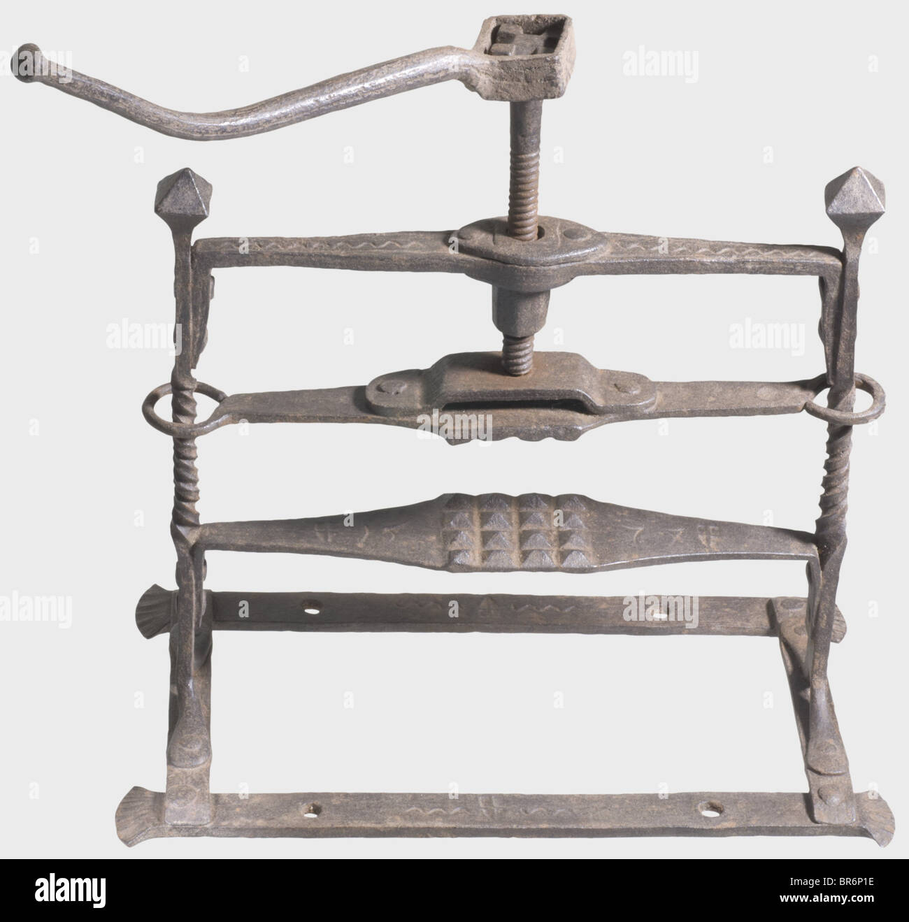 A hand crusher, Vienna(?), dated 1577. Wrought-iron construction, central threaded rod with detachable crank and moveable press. Twisted side bars with cubic finials. Dated on the hand support. Struck several times with the Vienna arsenal mark and ornated with sinuous lines and geometrical notch decorations. Signs of age. Width 48 cm, height 49 cm. historic, historical, 16th century, instrument of torture, torture device, instruments of torture, torture devices, object, objects, stills, clipping, clippings, cut out, cut-out, cut-outs, Stock Photo
