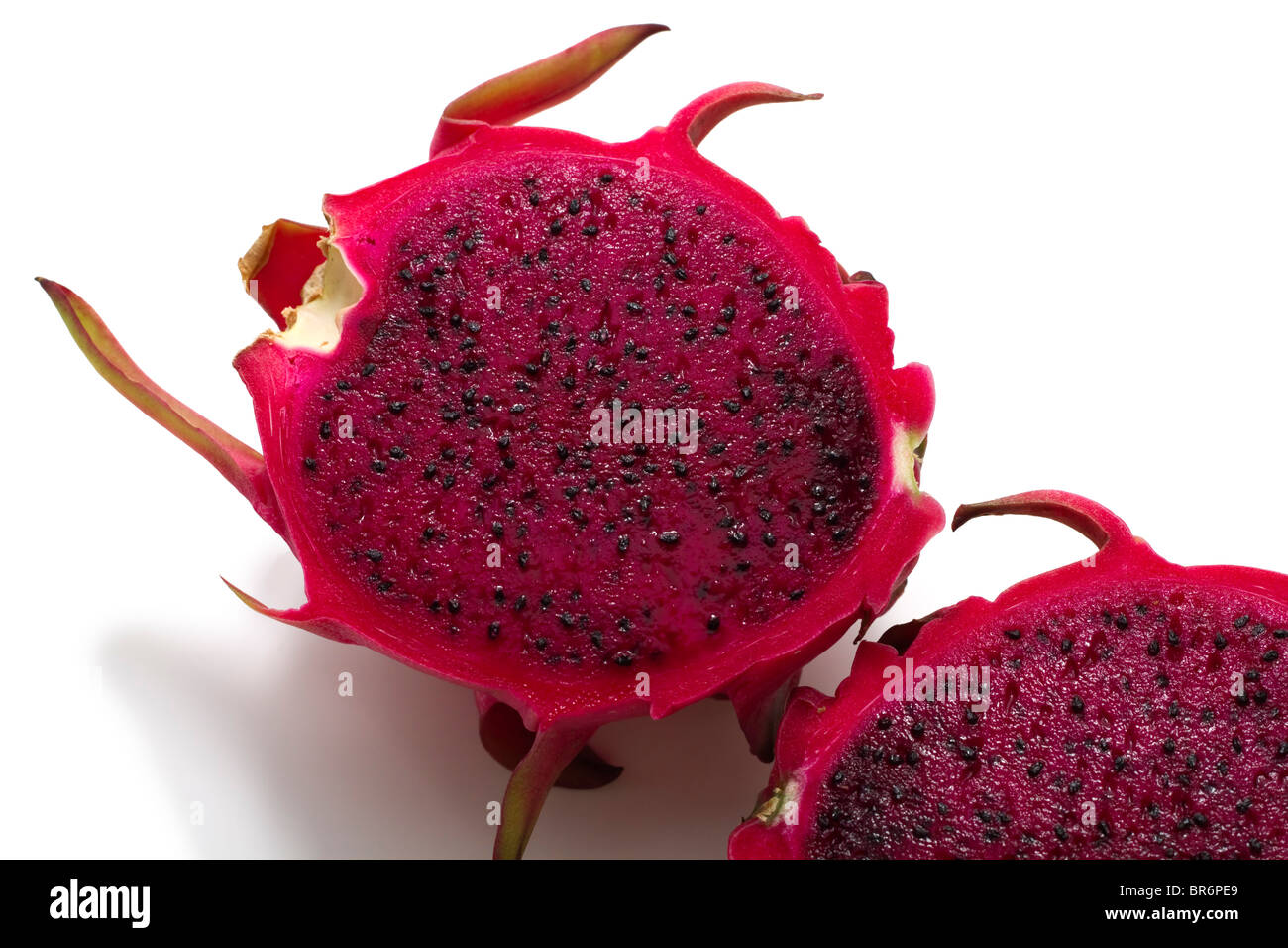 Delicious juicy exotic tropical red dragonfruit or pitaya with red flesh and black seeds Stock Photo