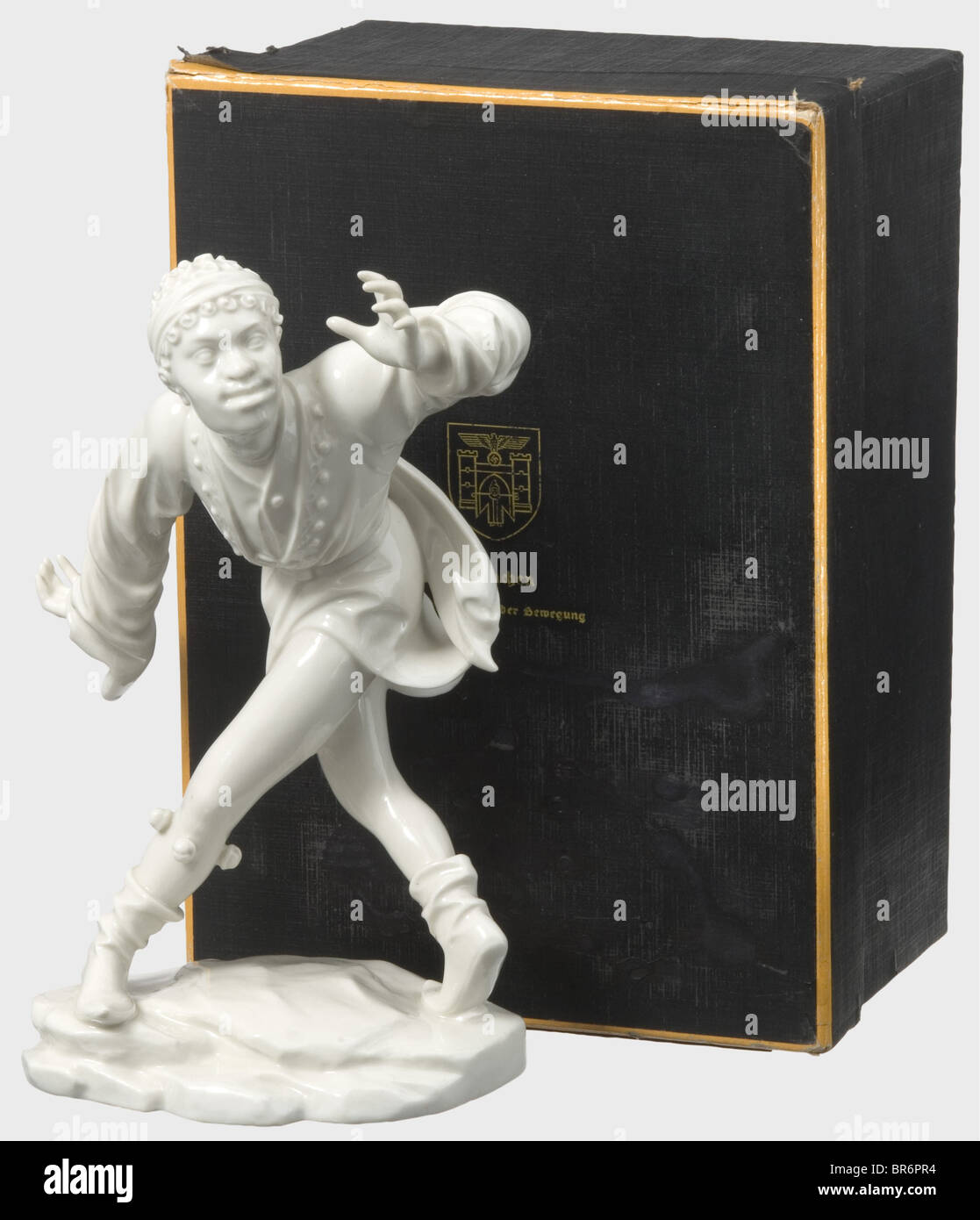The Moor in original box., White, glazed porcelain from the Morris Dancer series. Manufacturer's pressmark 'SS Allach' on the bottom. Restored hands. Height 22 cm. The original box imprinted on the lid 'München Hauptstadt der Bewegung' with the city's coat of arms, beneath it a retouched flaw, interior incomplete. Custom version without model number for the City of Munich, after the famous late Gothic wood figures by Erasmus Grasser exhibited in the Munich City Museum. Figure I, 'The Moor' appeared in 1939. historic, historical, people, 1930s, 20th century, obj, Stock Photo