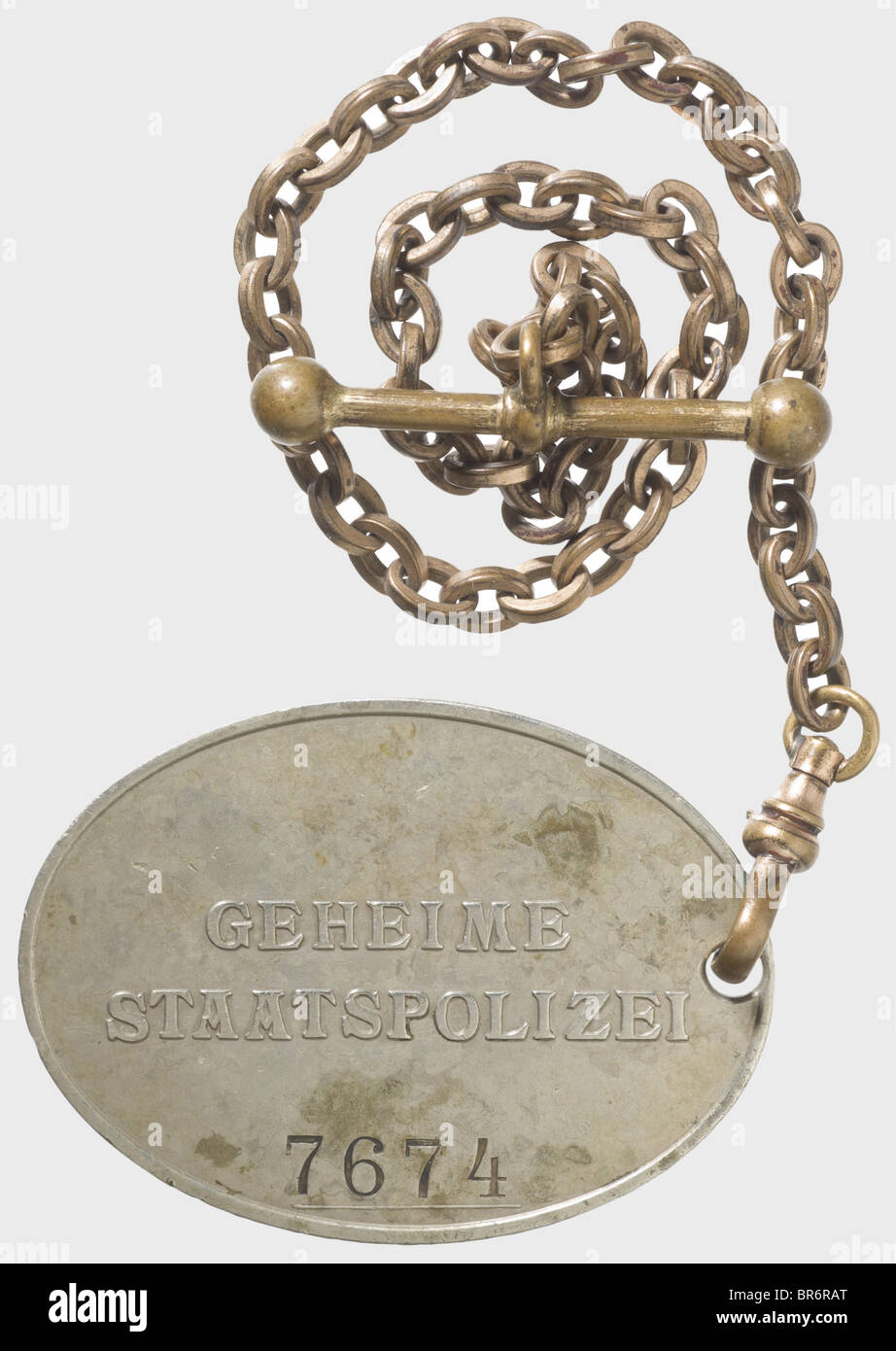 A badge '7674' of the GESTAPO., Nickel-silver, raised national eagle and the inscription 'GEHEIME STAATSPOLIZEI' (Secret State Police) in the typical caption, above the stamped number '7674'. Dimensions 37 x 51 mm. On a non-ferrous metal chain with snap hook and buttonhole toggle, also remnants of gilding. In addition an expertise of authenticity by Don Bible, September 2008. Of utmost rareness. historic, historical, 1930s, 1930s, 20th century, medal, decoration, medals, decorations, honouring, honor, honour, honors, honours, badge, badges, object, objects, sti, Stock Photo