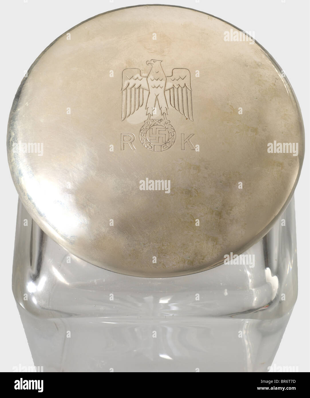 Eva Braun - a large cosmetic jar, from her private rooms in the New Reich Chancellery. Crystal glass with star-cut in the bottom, silver fittings with jeweller's mark and hallmark 'J. Herz 800' with crescent and crown. The lid bearing a national eagle above the initials 'R' and 'K'. Height 21.5 cm. Very rare container which was produced in silver only as special equipment for the private rooms of the New Reich Chancellery unlike the other articles of daily use in hard silver-plated version. historic, historical, 1930s, 1930s, 20th century, NS, National Socialis, Stock Photo