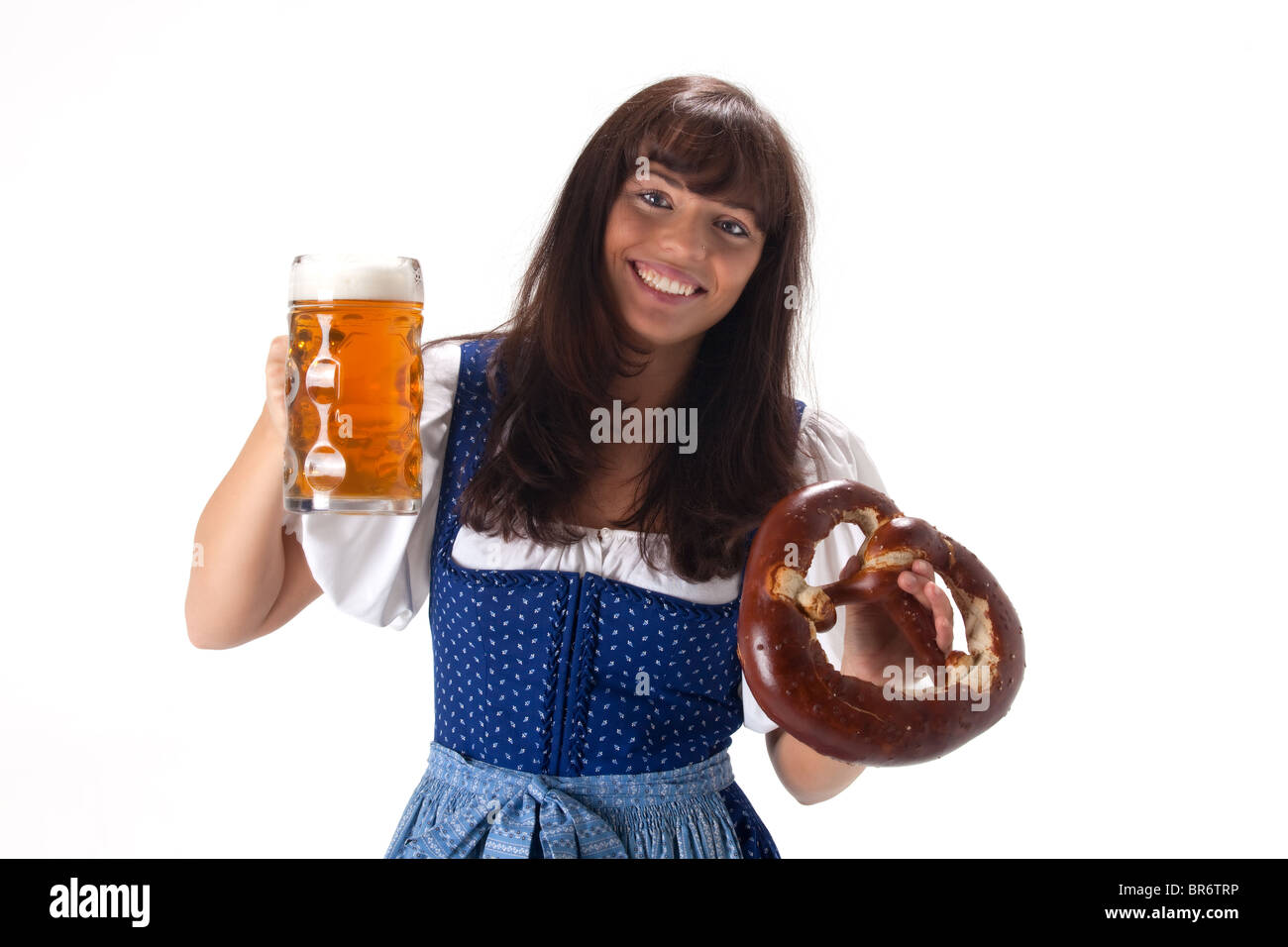 woman in a bavarian dress with beer and pretzel Stock Photo