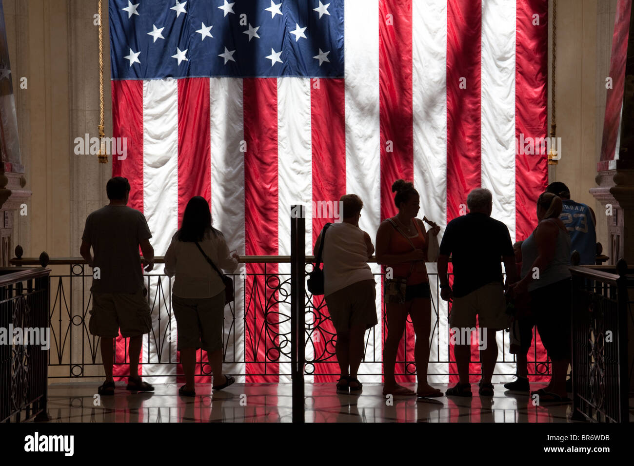 People silhouette; A group of people standing with the American Flag, the Venetian Hotel, Las Vegas USA Stock Photo